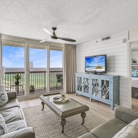 Welcome to Pelican Beach 1915 - Cloud Nine! Relax in this bright living space with coastal views from your private balcony and cozy seating for unwinding after beach days.