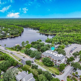 A scenic aerial view showing the home nestled beside the rare coastal dune lake and Gulf nearby.