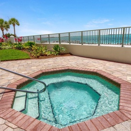 Soak in your private hot tub while enjoying stunning ocean views and tropical landscaping in this beachfront paradise.