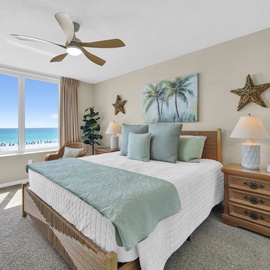 Wake up to stunning ocean views and beach scenes right from your bed in this serene coastal bedroom.