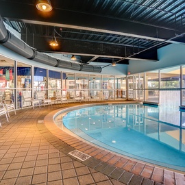 Dive into relaxation in this beautiful indoor pool surrounded by comfortable lounge chairs and floor-to-ceiling windows.