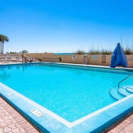 Sparkling blue pool awaits your refreshing dips under endless Florida sunshine, with convenient poolside seating for ultimate relaxation.