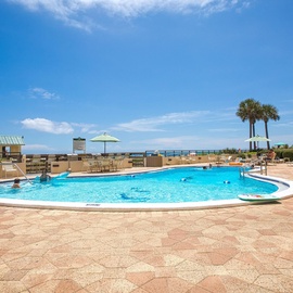 Sparkling beachfront pool with crystal-clear water where you'll spend sun-soaked days relaxing under tropical palms.