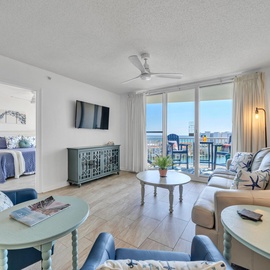 Relax in your bright living space with stunning ocean views through floor-to-ceiling windows and comfortable seating for your perfect getaway.