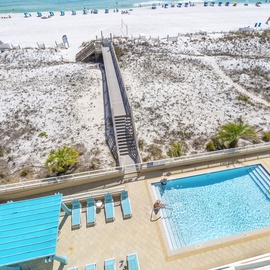 Overlooking the Gulf, a private boardwalk leads from tranquil poolside to pristine white sands.