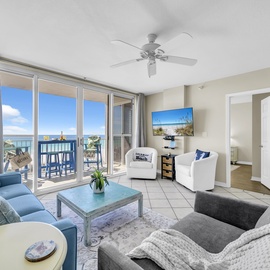 Sink into coastal comfort in your bright living space, where ocean views stretch endlessly beyond your private balcony and gentle sea breezes flow through.