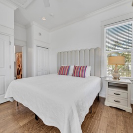 Slip into fresh linens and sink into your cozy bed, where colorful pillows add charm to this bright, peaceful bedroom retreat.