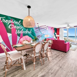 Step into your vibrant tropical paradise, where bold pink accents and ocean views create an unforgettable beachfront escape.