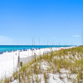 Pristine white sand beach with turquoise waters and coastal condos creates the perfect Gulf Coast destination.