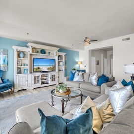 Sink into plush turquoise chairs and unwind in this bright, coastal-themed living room where ocean hues and natural light create your perfect retreat.