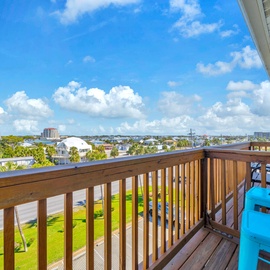 Sunset Cottages 2C - Melrose Place has panoramic coastal view stretching across lush neighborhoods and distant buildings under a brilliant blue sky.