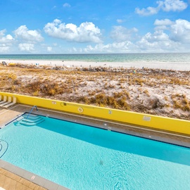 Elevated poolside setting overlooking the shoreline, perfect for a refreshing escape with a view.