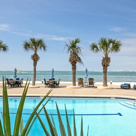 Dive into crystal-clear waters while palm trees sway overhead, then unwind with gulf views from your poolside paradise.