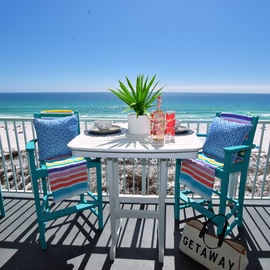 A colorful balcony setup made for coastal living, where Gulf views pair perfectly with a refreshing drink.