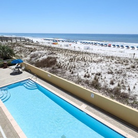 Pelican Isle features a community pool overlooking pristine white sand beaches and Gulf waters with convenient beach access.