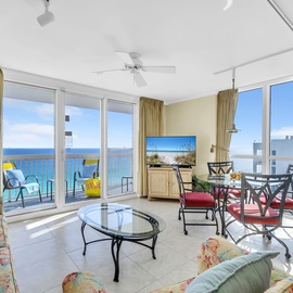 Relax in your bright oceanfront living space with stunning sea views, comfortable seating, and direct access to the private balcony.