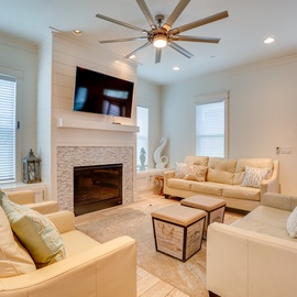 Sink into plush leather seating around the warm fireplace, where your evening conversations flow as naturally as the ceiling fan's gentle breeze.