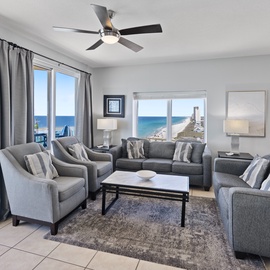 Relax in your spacious living room with stunning ocean views, where the gentle ceiling fan and plush seating create the perfect coastal retreat.