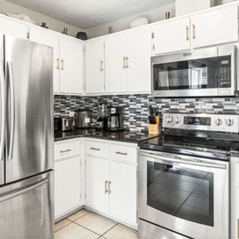 Step into your fully equipped kitchen with stainless steel appliances, stylish backsplash, and everything you need to create memorable meals during your stay.