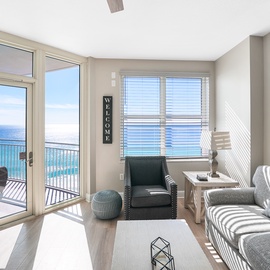 Relax in your bright living room with stunning ocean views through floor-to-ceiling windows and direct balcony access to your private outdoor space.