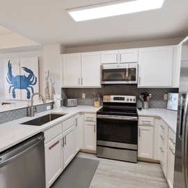 Cook your favorite meals in this bright, fully-equipped kitchen with modern appliances and charming coastal touches.