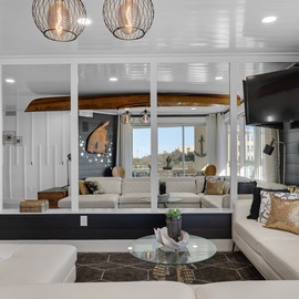 Unwind in your sophisticated living space with plush seating, designer lighting, and stunning city views through floor-to-ceiling windows.