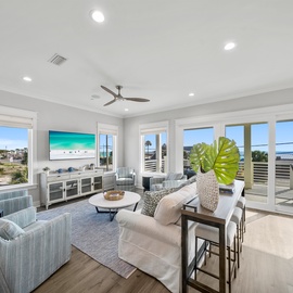 Unwind in your bright living space with ocean views and coastal breeze flowing through floor-to-ceiling windows.