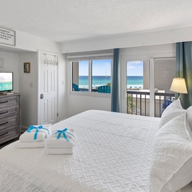 Wake up to stunning ocean views from your comfortable bed, with crisp white linens and thoughtful touches awaiting your perfect beach getaway.