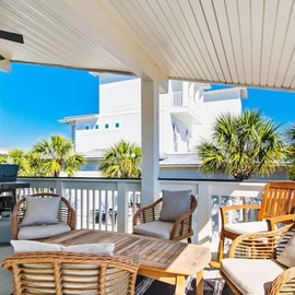 Relax in your private covered terrace with stylish rattan seating and tropical palms swaying beyond.
