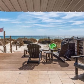 Your private deck overlooks pristine white sand and turquoise waters, with comfortable Adirondack chairs perfect for morning coffee or sunset cocktails.