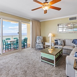 Relax in your bright oceanfront living room where floor-to-ceiling windows frame endless sea views and your private balcony awaits.