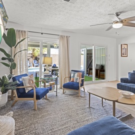 Sink into plush blue seating and feel the coastal breeze through sliding doors leading to your private outdoor space.