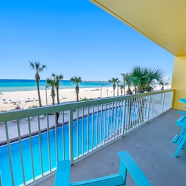 Sip your morning coffee on your private balcony while watching waves roll onto pristine sand. Turquoise chairs invite you to unwind.