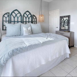 Sink into your serene sanctuary with soft linens and charming architectural details creating the perfect coastal retreat.