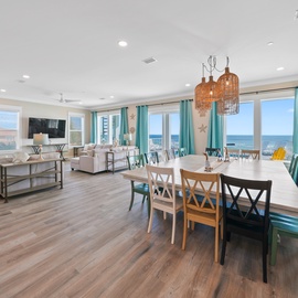 Your spacious living and dining area flows seamlessly together, with stunning ocean views through every window and coastal-inspired décor creating the perfect beach house atmosphere.