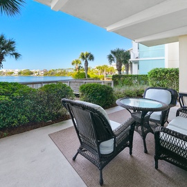 Your private patio offers peaceful lakefront views where you can unwind with morning coffee or evening cocktails in comfortable wicker seating.