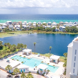 Stunning aerial view showcasing the beachfront property's prime location between pristine turquoise waters and a peaceful lagoon.