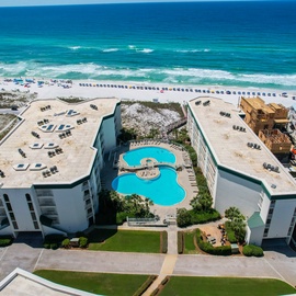 Beachfront property with direct access to pristine white sand and turquoise waters, featuring a stunning pool complex.