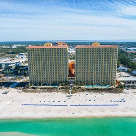 Beachfront twin towers rise majestically along pristine white sand and emerald waters, offering direct beach access.
