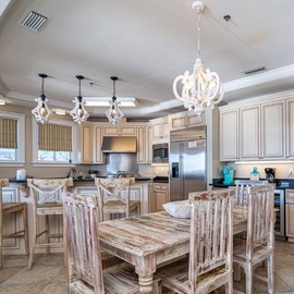 Your gourmet kitchen welcomes you with granite counters, elegant pendant lighting, and a rustic dining table perfect for sharing meals.