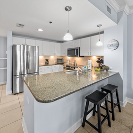Your spacious kitchen features granite countertops, stainless steel appliances, and a breakfast bar where you can enjoy morning coffee.