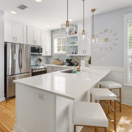 Step into your bright, fully-equipped kitchen where morning coffee and home-cooked meals feel effortless. Sunlight streams through large windows, illuminating sleek countertops and stainless appliances—your culinary retreat awaits.