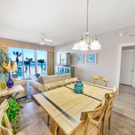 Your open-concept living space flows seamlessly from dining to living room, with ocean views greeting you through floor-to-ceiling windows.
