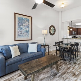Relax in your stylish open-concept retreat where coastal blues meet modern comfort, perfectly connecting your living and dining spaces.