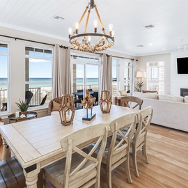 Wake up to stunning ocean views from your bright, coastal living space where beach breezes flow through expansive windows.