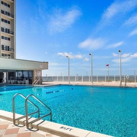 Dive into crystal-clear waters at this stunning oceanfront pool where endless blue skies meet refreshing swims.