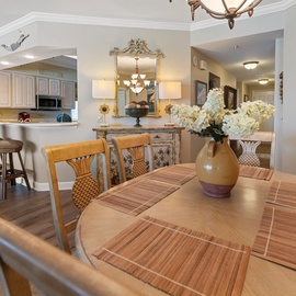 Gather around your elegant dining table where fresh flowers welcome you home after beach days, while the open kitchen invites culinary adventures.