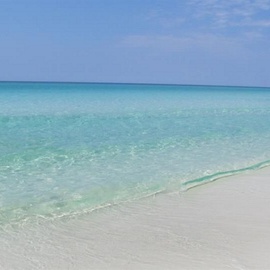 Crystal-clear turquoise waters meet pristine white sand at this stunning beachfront location.
