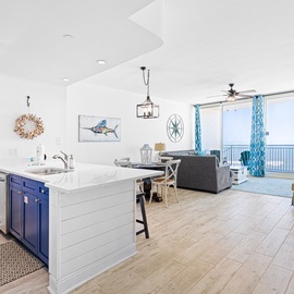 Relax in your bright, coastal-themed space with ocean views and a fully equipped kitchen for preparing memorable meals.
