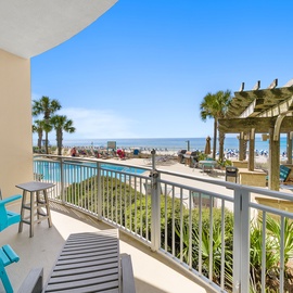 Step onto your private balcony and soak in stunning ocean views, turquoise pool, and swaying palms—your perfect coastal retreat awaits.